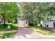 Charming two-story home with a well-maintained lawn, mature trees, and a private driveway leading to an attached garage at 459 Presidents Ct, Charlotte, NC 28217