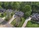 Aerial view of a suburban neighborhood showcasing a two-story brick home with lush landscaping at 4619 Glasgow Ct, Gastonia, NC 28056