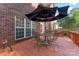 Enjoy the deck of this home featuring an umbrella table and wooded views at 4619 Glasgow Ct, Gastonia, NC 28056