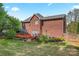 Expansive backyard features a deck, patio, manicured landscaping, and beautiful brick home in a suburban setting at 4619 Glasgow Ct, Gastonia, NC 28056