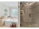 Modern bathroom features a walk-in glass shower and a separate bathtub with tiled walls and flooring at 4619 Glasgow Ct, Gastonia, NC 28056
