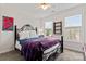 Cozy bedroom featuring a decorative wrought iron bed frame, neutral walls, and lots of natural light at 4619 Glasgow Ct, Gastonia, NC 28056