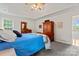 Spacious bedroom features a large bed, ceiling fan, and decorative vintage wardrobe at 4619 Glasgow Ct, Gastonia, NC 28056