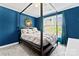 This bedroom features an accent wall, canopy bed and modern finishes at 4619 Glasgow Ct, Gastonia, NC 28056