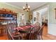 Elegant dining room features hardwood floors, a wooden table, and a traditional hutch for display at 4619 Glasgow Ct, Gastonia, NC 28056