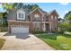 Charming two-story brick home with well-manicured lawn and attached two-car garage at 4619 Glasgow Ct, Gastonia, NC 28056