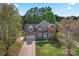 Charming two-story brick home with well-manicured lawn and attached two-car garage from aerial perspective at 4619 Glasgow Ct, Gastonia, NC 28056