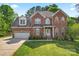 Charming two-story brick home with well-manicured lawn and attached two-car garage at 4619 Glasgow Ct, Gastonia, NC 28056