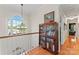 The hallway is well-lit with hardwood floors and showcases a bookshelf near a large window at 4619 Glasgow Ct, Gastonia, NC 28056
