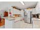 Well-lit kitchen offers stainless steel refrigerator, lots of counterspace, and ample cabinet storage at 4619 Glasgow Ct, Gastonia, NC 28056