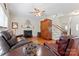 Comfortable living room features fireplace, ceiling fan, hardwood floors, and stairs leading to the second story at 4619 Glasgow Ct, Gastonia, NC 28056