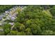 A wooded lot features a single-Gathering home near other homes in a neighborhood with lush greenery from above at 500 Peigler Nw St # Lots 1 & 2, Concord, NC 28027