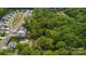 Single-Gathering home and wooded lot surrounded by a neighborhood and lush green trees from above at 500 Peigler Nw St # Lots 1 & 2, Concord, NC 28027
