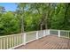 Spacious wooden deck with white railings, offering scenic views of the surrounding greenery at 500 Peigler Nw St # Lots 1 & 2, Concord, NC 28027