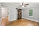 Bedroom with hardwood floors, a rustic barn door to closet, and an abundance of natural light at 500 Peigler Nw St # Lots 1 & 2, Concord, NC 28027