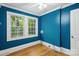 Bedroom featuring bold blue walls, hardwood floors, a bright window and utility hookups for convenience at 500 Peigler Nw St # Lots 1 & 2, Concord, NC 28027