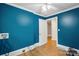 Bedroom showing a vibrant blue accent wall, hardwood floors, and ample space for personalization at 500 Peigler Nw St # Lots 1 & 2, Concord, NC 28027