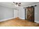 Bedroom featuring hardwood floors and sliding barn door closet at 500 Peigler Nw St # Lots 1 & 2, Concord, NC 28027