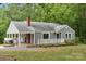 Well-maintained single-story home with a covered porch, brick chimney, and landscaped front yard at 500 Peigler Nw St # Lots 1 & 2, Concord, NC 28027