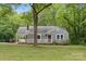 Charming gray home with a welcoming porch, set amidst lush greenery and mature trees at 500 Peigler Nw St # Lots 1 & 2, Concord, NC 28027