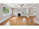 Open living room featuring hardwood floors, fireplace, and natural light from multiple windows at 500 Peigler Nw St # Lots 1 & 2, Concord, NC 28027