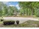 Expansive backyard featuring a full sports court, lush landscaping, and a charming multi-story home beyond at 507 Richards Dr, Shelby, NC 28150