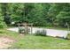 Backyard sports court area features basketball hoops and brick trim surrounded by mature trees at 507 Richards Dr, Shelby, NC 28150