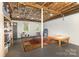 Spacious unfinished basement with painted walls, exposed ceiling, and natural light at 507 Richards Dr, Shelby, NC 28150
