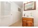 Bright bathroom features a wood vanity, medicine cabinet, and white tiled walls at 507 Richards Dr, Shelby, NC 28150