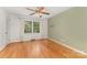 Sunny bedroom features hardwood floors, a ceiling fan and a large window at 507 Richards Dr, Shelby, NC 28150