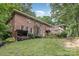Brick home showcases a tiered deck, a cozy wood shed, and lush greenery, offering privacy and charm at 507 Richards Dr, Shelby, NC 28150