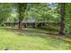 Charming brick home featuring a manicured lawn, mature trees, and classic architectural details at 507 Richards Dr, Shelby, NC 28150