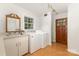 Well-lit laundry room with a sink, wooden door, and front load washer and dryer at 507 Richards Dr, Shelby, NC 28150