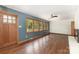 Bright living room features a ceiling fan, wood floors, and a wall of windows at 507 Richards Dr, Shelby, NC 28150