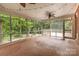Spacious screened porch with a ceiling fan and views of the wooded backyard at 507 Richards Dr, Shelby, NC 28150
