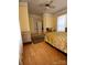 Bright bedroom with vintage furniture and a ceiling fan for added comfort and style at 514 N Main St, Mount Gilead, NC 27306