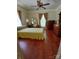 Expansive bedroom with a ceiling fan, generous natural light, and lustrous hardwood floors at 514 N Main St, Mount Gilead, NC 27306