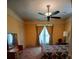 Inviting bedroom featuring a ceiling fan, vintage furnishings, and natural light from the window at 514 N Main St, Mount Gilead, NC 27306