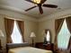 Large bedroom with ceiling fan, substantial natural light, and classic decor at 514 N Main St, Mount Gilead, NC 27306