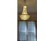 Stunning crystal chandelier hangs over a window with sheer curtains, adding elegance to the room at 514 N Main St, Mount Gilead, NC 27306