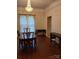 Traditional dining room with hardwood floors, chandelier, fireplace, and ample natural light at 514 N Main St, Mount Gilead, NC 27306