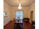 Traditional dining room with hardwood floors, chandelier, fireplace, and ample natural light at 514 N Main St, Mount Gilead, NC 27306