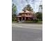 Charming brick home featuring a wide front porch, complemented by classic architectural details at 514 N Main St, Mount Gilead, NC 27306