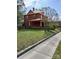 A classic home with a side yard view, displaying its brick facade and inviting porch at 514 N Main St, Mount Gilead, NC 27306