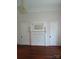 Classic fireplace design with detailed carvings, and chandelier at 514 N Main St, Mount Gilead, NC 27306