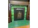 Unique fireplace with ornate detailing and green accents adding charm to the space at 514 N Main St, Mount Gilead, NC 27306