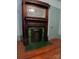 Antique fireplace with wood trim and green tile accent adds character to the home at 514 N Main St, Mount Gilead, NC 27306
