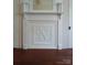 Charming fireplace design with detailed carvings, providing a focal point in the room at 514 N Main St, Mount Gilead, NC 27306