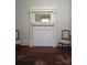 Elegant fireplace design with detailed carvings, flanked by matching chairs at 514 N Main St, Mount Gilead, NC 27306