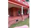 Covered front porch showcasing its brick facade and classic rocking chairs at 514 N Main St, Mount Gilead, NC 27306